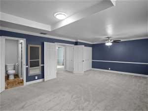 Interior space featuring ceiling fan and crown molding