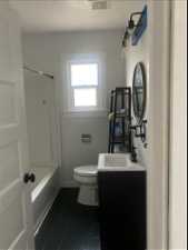 Full bathroom featuring shower / washtub combination, toilet, vanity, and a textured ceiling