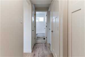 Hallway featuring light hardwood (LVP)/ wood-style flooring