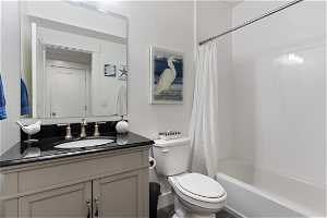 Full bathroom with vanity, shower cultured marble to the ceilings / bath combo, and toilet