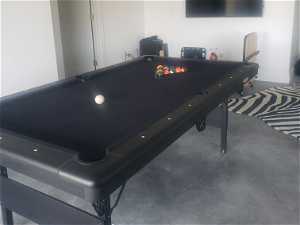 Game room with concrete flooring
