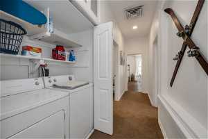 Laundry area with carpet flooring and washer and clothes dryer