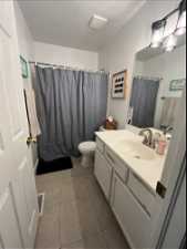 Additional Bathroom featuring vanity, toilet, and tile flooring