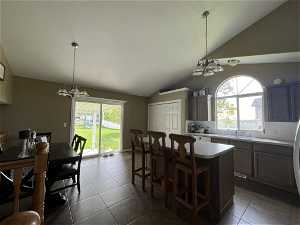 Kitchen - light fixtures, and an inviting chandelier with access to backyard