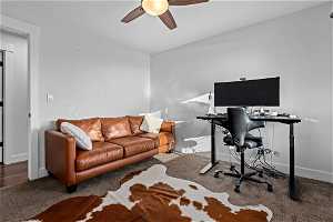Office featuring ceiling fan and dark carpet