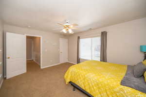 Carpeted bedroom featuring ceiling fan