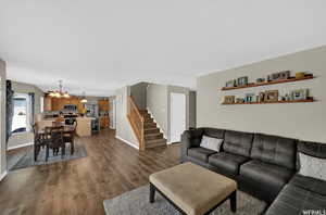 Living room featuring hardwood / wood-style floors, sink, and a chandelier