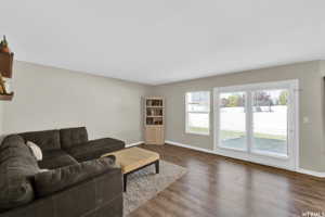 Living room featuring dark hardwood / wood-style flooring