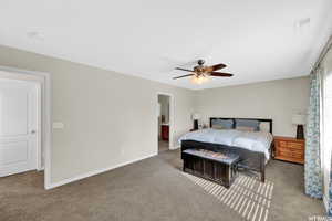 Bedroom with ceiling fan and carpet