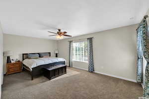 Bedroom with ceiling fan and carpet floors