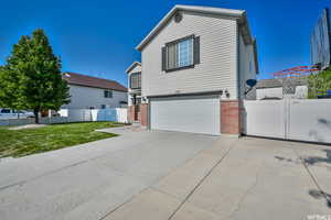 View of front of house with a front yard and a garage