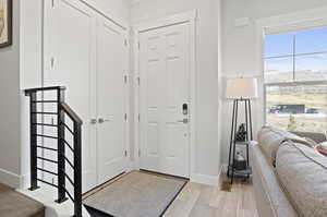 Entryway with light hardwood / wood-style floors