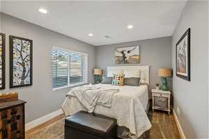 Hardwood floored bedroom featuring natural light