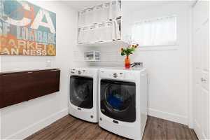 Laundry room featuring washer hookup, separate washer and dryer, and dark hardwood / wood-style floors