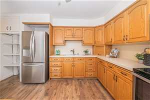 Kitchen featuring hardwood / wood-style floors, stainless steel appliances, and sink