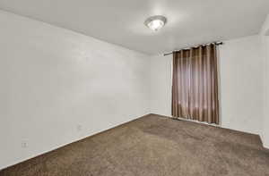 Unfurnished room with carpet flooring