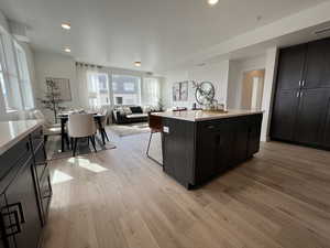 Kitchen featuring plenty of natural light, a center island, and light hardwood / wood-style floors