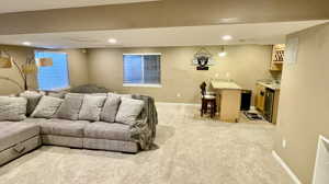 Living room featuring light colored carpet and sink