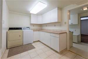 Basement Laundry Room with Lots of Cabinets and Counter Top Space for Folding, and Drop Down Ironing Board!