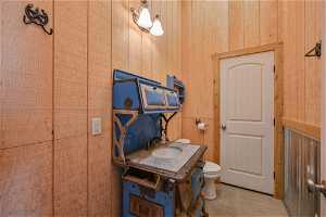 Misc room with wood walls and sink