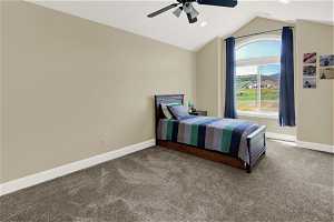 Bedroom featuring vaulted ceiling, ceiling fan, and carpet