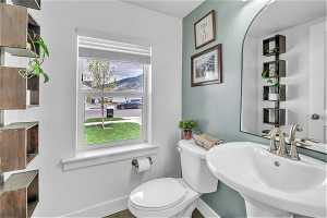 Bathroom with a healthy amount of sunlight, sink, a mountain view, and toilet