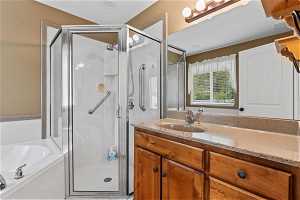 Bathroom featuring separate shower and tub and large vanity