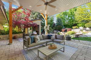 View of patio with an outdoor living space and ceiling fan