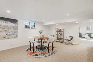 Dining area with a wealth of natural light and light carpet