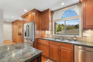 Kitchen featuring backsplash, stainless steel appliances, and granite countertops