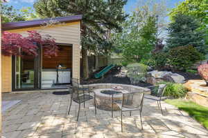 View of patio featuring a fire pit and gazebo enclosed hot tub