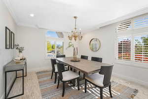 Dining space with plenty of natural light, crown molding