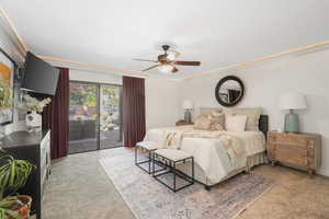 Primary Bedroom featuring ornamental molding, light colored carpet, ceiling fan, and access to exterior