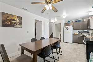 Dining area featuring ceiling fan and light tile floors