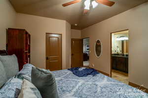 Bedroom 3 upstairs featuring ensuite bath, sink, ceiling fan, and light tile floors