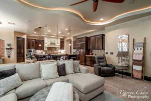 Living room featuring light colored carpet and ceiling fan