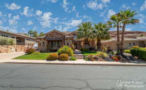 Mediterranean / spanish home featuring a front lawn