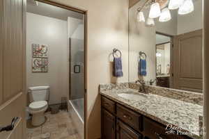 Jack & Jill bathroom between bedrooms 4&5 upstairs.  vanity with extensive cabinet space, tile floors, toilet, and enclosed tub / shower combo