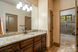 Jack & Jill bathroom between bedrooms 4 & 5 upstairs. Features vanity, tiled shower / bath, and tile flooring