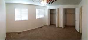 Unfurnished bedroom with carpet and multiple closets