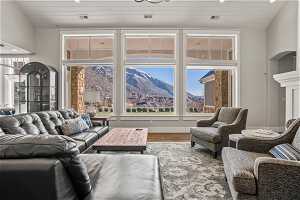 Living room with a fireplace, plenty of natural light, hardwood / wood-style flooring, and a mountain view