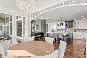 Dining area with a chandelier, sink, and dark hardwood / wood-style flooring