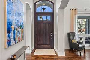 Foyer entrance with dark hardwood / wood-style flooring and a wealth of natural light