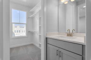 Bathroom featuring a healthy amount of sunlight and vanity