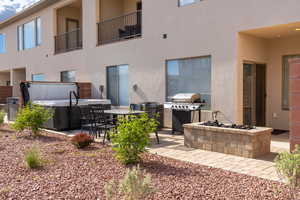 Back of property with a patio and a balcony