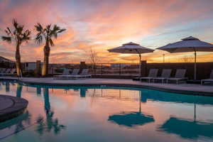 Pool at dusk with a patio area