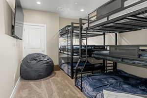 Bedroom featuring light carpet