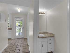 Bathroom featuring tile flooring, a textured ceiling, and large vanity