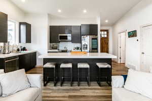 Kitchen with a center island, appliances with stainless steel finishes, sink.