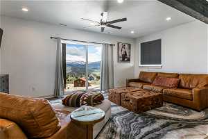 Living room featuring a mountain view and ceiling fan